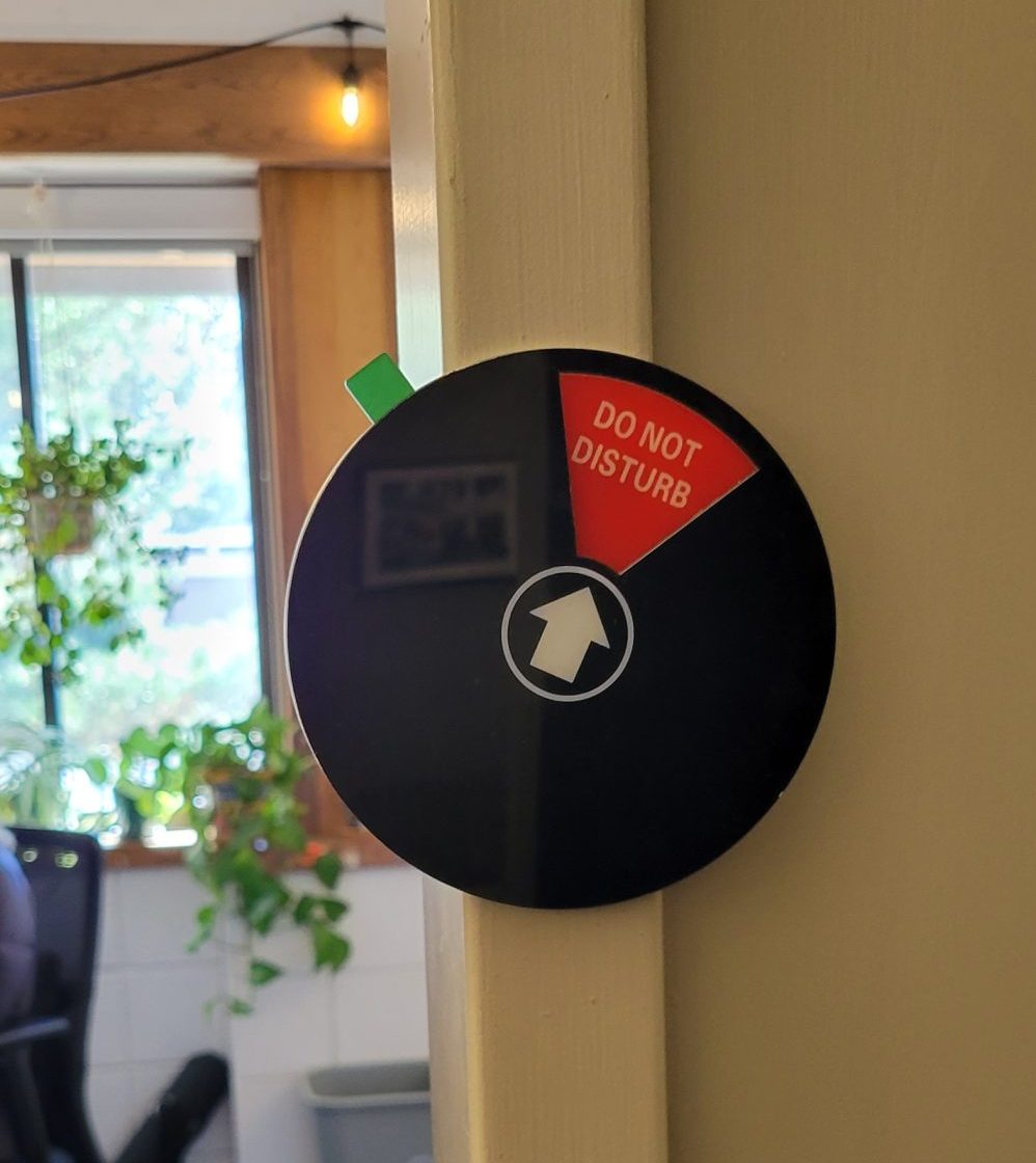Black circle with a red triangle at its top that says "Do Not Disturb"